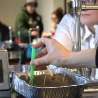 Teacher takes a dirt sample during a professional learning opportunity.